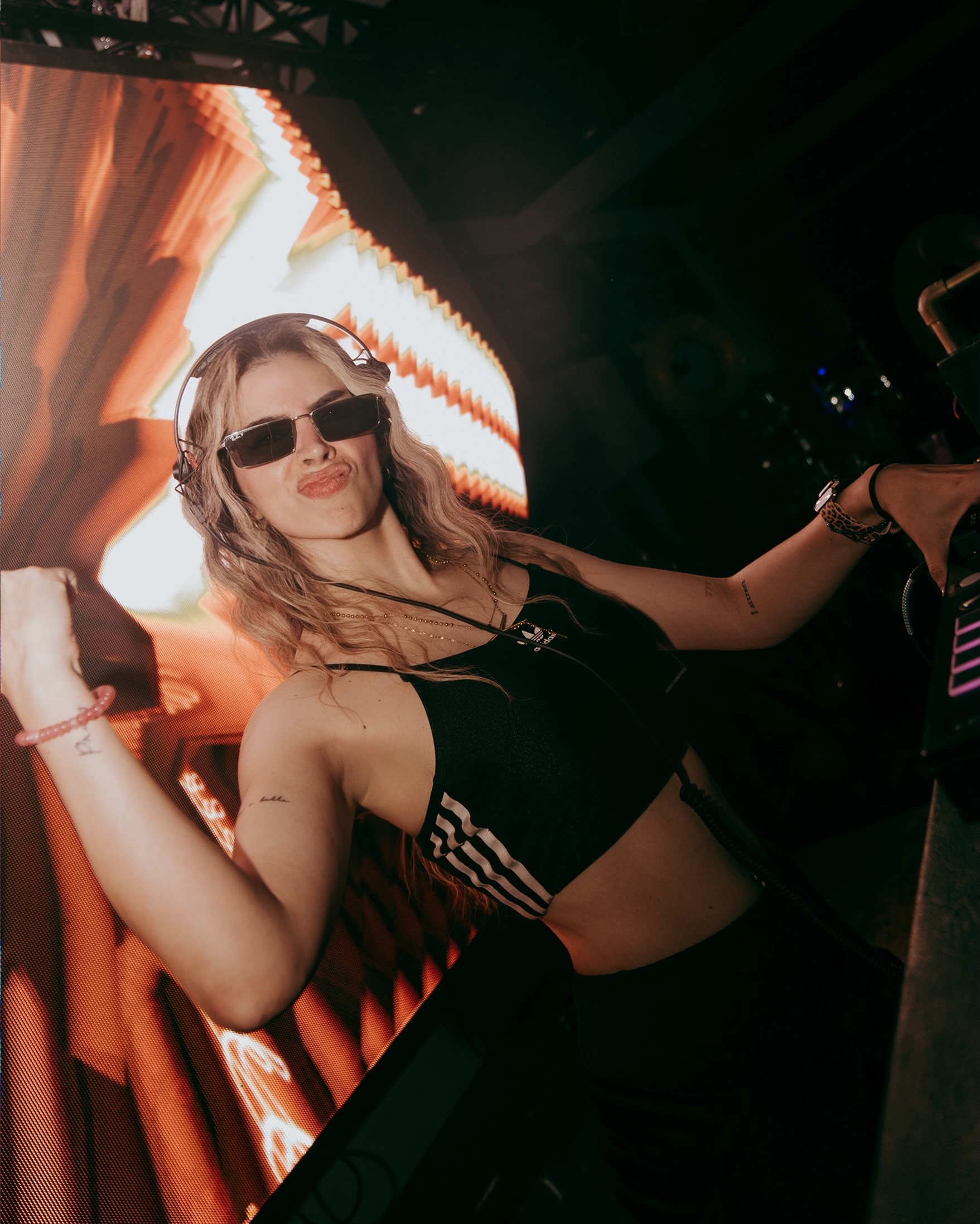DJ Yessi portrait in neon club lighting